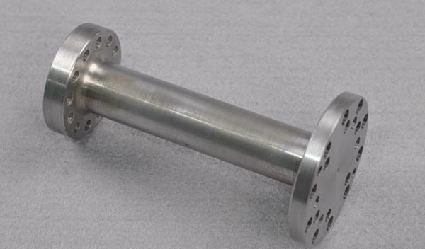 metal alloy shaft part with holes