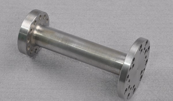 metal alloy shaft part with holes